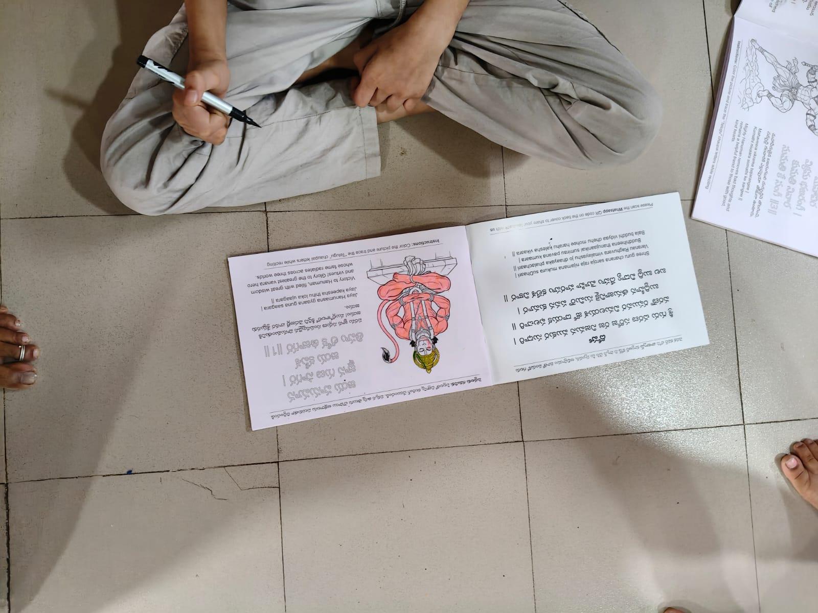 Child coloring and tracing the Hanuman Chalisa — #25